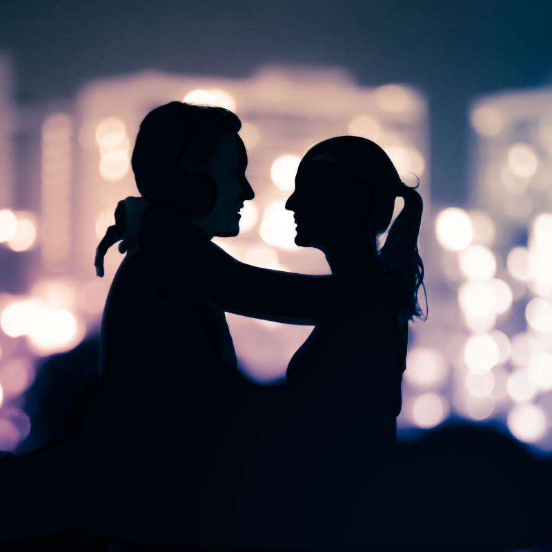 Couple on a date night, silhouette on UK city background