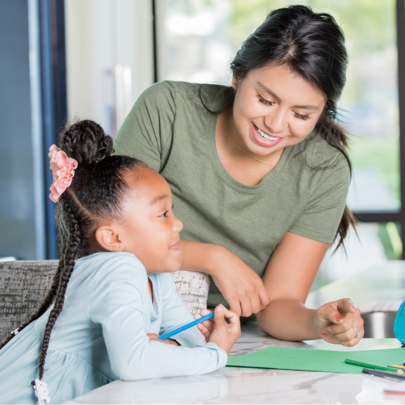 Part-time nanny helps child with craft work